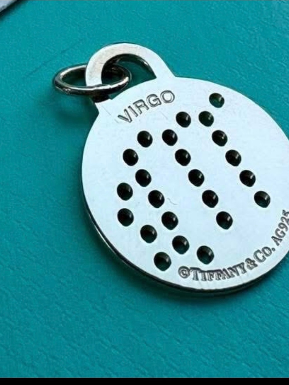 Tiffany & Co. Silver Virgo Round Pendant on Aqua Background